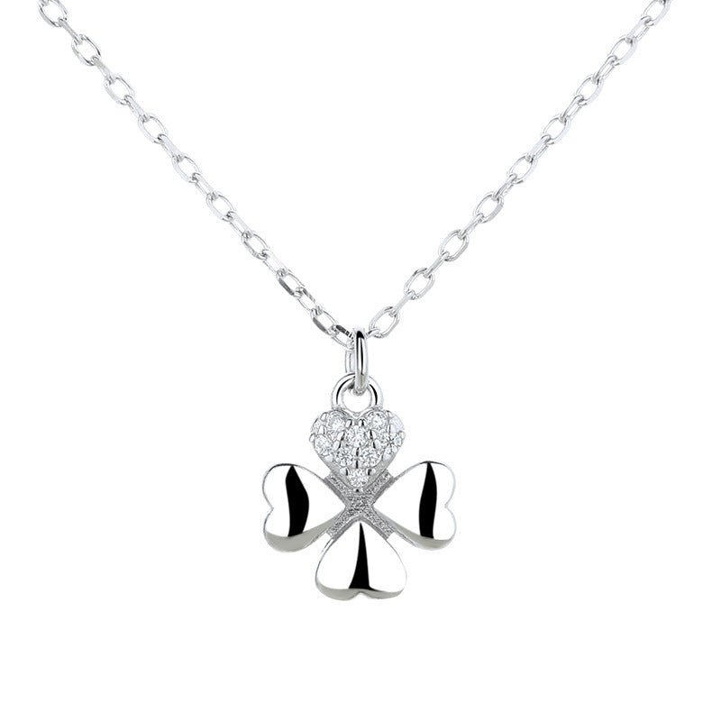 Silver necklace with a clover-shaped pendant on a white background
