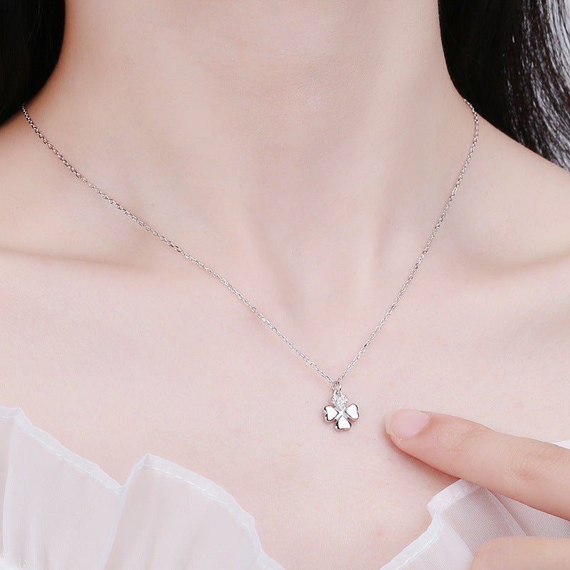 Silver necklace with a delicate pendant worn by a person