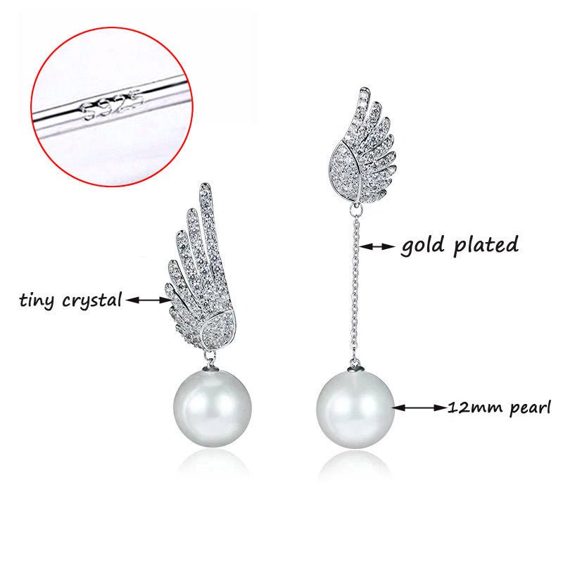 Pearl earrings with gold plating and crystals on a white background