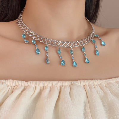 Necklace with blue stones worn by a model against a neutral background