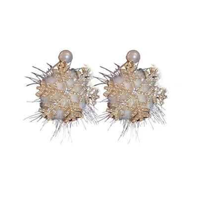Pair of gold and pearl earrings on a white background