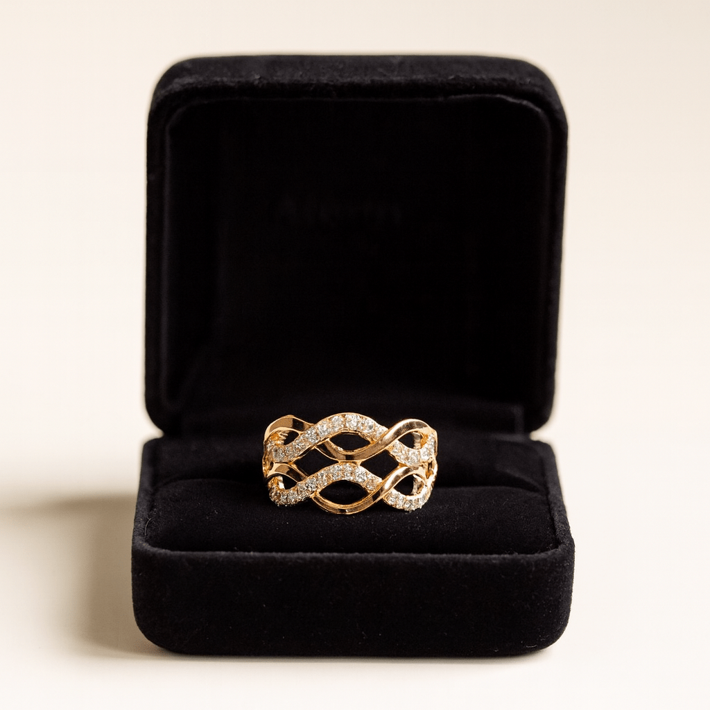 Gold ring with diamond accents in a black jewelry box on a light background