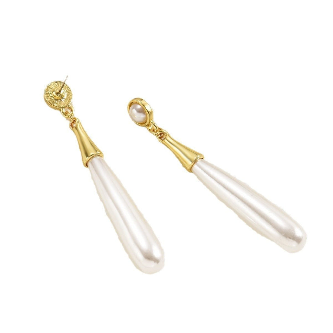 Gold and pearl drop earrings on a white background
